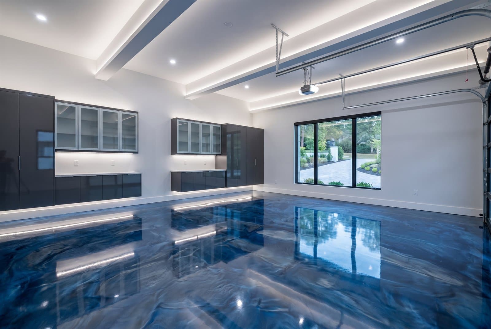 Deep blue metallic epoxy floor in a modern residential garage