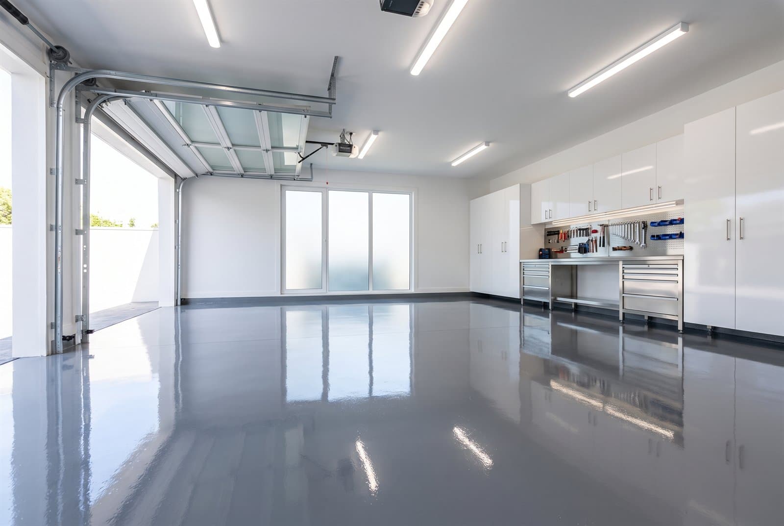 High-gloss solid grey epoxy floor in a clean residential garage