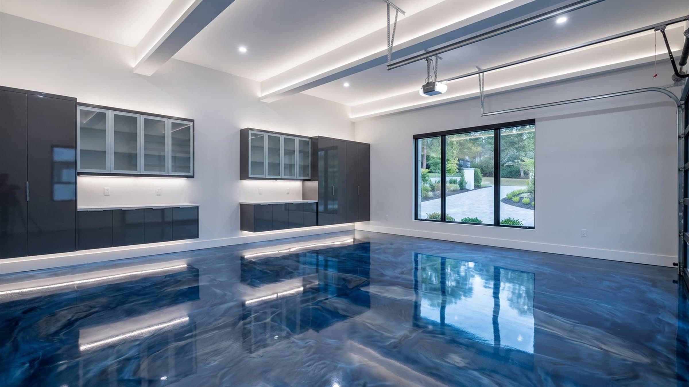 Deep blue metallic epoxy floor in a residential garage — Cedar Rapids IA